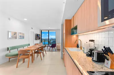 a kitchen with a long table and chairs in a room at Luxury Bayfront Condo - Downtown Location in Miami