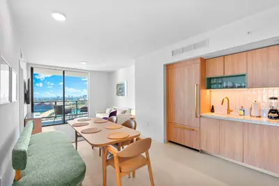 a kitchen and dining room with a table and chairs at Luxury Bayfront Condo - Downtown Location in Miami
