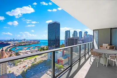 a balcony with a view of the city and the ocean at Luxury Bayfront Condo - Downtown Location in Miami