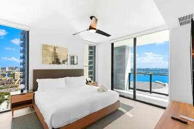 a bedroom with a bed and a large window at Luxury Bayfront Condo - Downtown Location in Miami