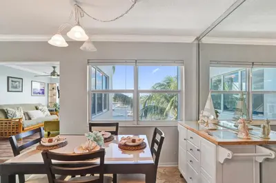 a kitchen and dining room with a table and chairs at Fort Lauderdale Waterfront Condo! Pool and Marina Views in Fort Lauderdale