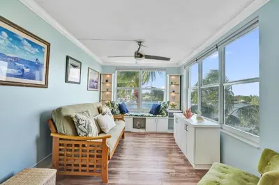 a living room with a couch and windows at Fort Lauderdale Waterfront Condo! Pool and Marina Views in Fort Lauderdale