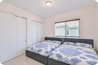 two beds in a bedroom with white walls at Supremacy Villa STR-6110 in Davie
