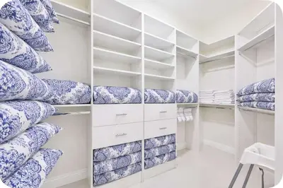a walk in closet with blue and white pillows at Supremacy Villa STR-6110 in Davie