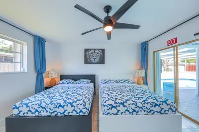 a bedroom with two beds and a ceiling fan at Eat Pray Love Villa in Hollywood
