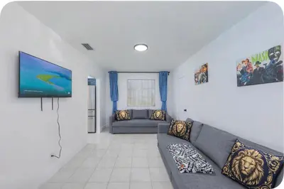 a living room with a couch and a flat screen tv at Eat Pray Love Villa in Hollywood