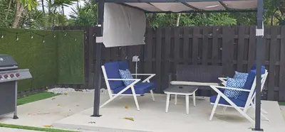 a patio with chairs and a table and a grill at Sunrise Oasis in Sunrise
