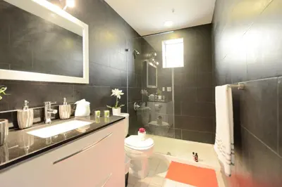 a bathroom with a sink and a toilet and a tub at Art Deco Ocean Drive Suites in Miami Beach