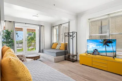 a living room with a tv and a couch at Art Deco Ocean Drive Suites in Miami Beach