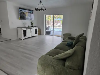 a living room with a large green couch in a room at Sunrise Oasis in Sunrise