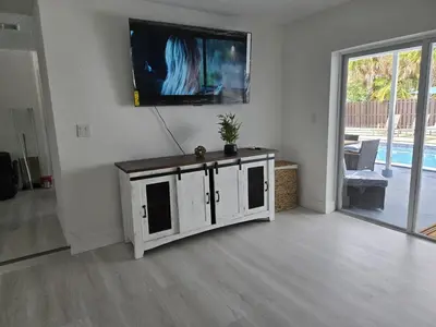a living room with a tv on a wall at Sunrise Oasis in Sunrise