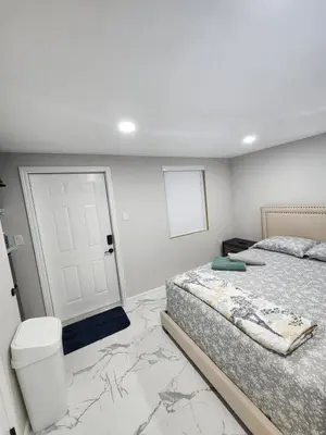 a bedroom with two beds and a white door at Amazing room in Hollywood in Carver Ranches