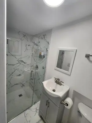 a white bathroom with a sink and a shower at Amazing room in Hollywood in Carver Ranches
