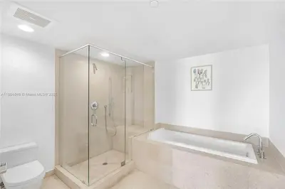 a bathroom with a shower and a tub and a toilet at Icon Brickell Penthouse Panoramic Skyline by IliosRentals in Miami