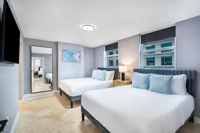 a hotel room with two beds and a mirror at Brickell Ocean View Condo with Free Parking in Miami