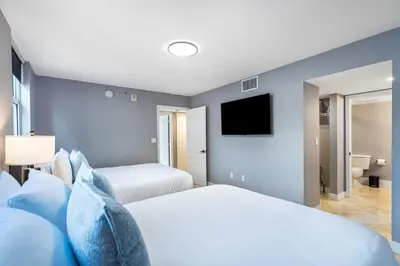 a bedroom with two beds and a flat screen tv at Brickell Ocean View Condo with Free Parking in Miami