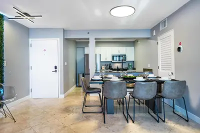 a kitchen and dining room with a table and chairs at Brickell Ocean View Condo with Free Parking in Miami