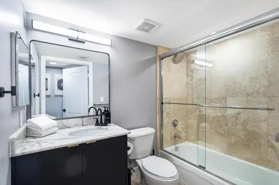 a bathroom with a shower and a toilet and a sink at Brickell Ocean View Condo with Free Parking in Miami