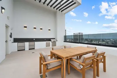 a dining room with a table and chairs and a large window at Modern Downtown Miami Condo w Pool and Gym in Miami