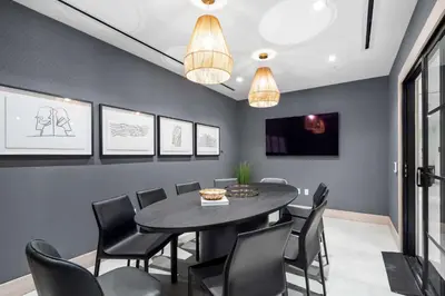 a dining room with a black table and chairs at Modern Downtown Miami Condo w Pool and Gym in Miami