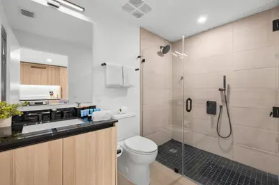 a bathroom with a shower and a toilet and a sink at Modern Downtown Miami Condo w Pool and Gym in Miami