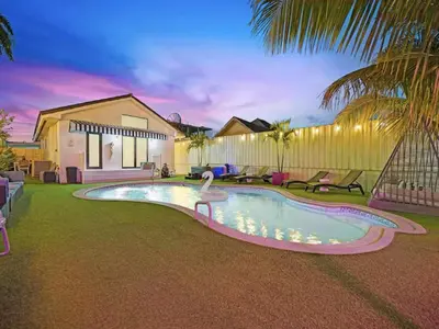 a swimming pool with a swan in a house at The Gilded Palm - Near Design District - Pool & Hot Tub in Miami