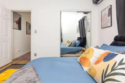 a bedroom with two beds and a mirror at Serene Cottage Retreat Ideal for Couples & Solo Travelers in Miami