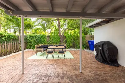 a pavilion with a table and chairs on a brick patio at Serene Cottage Retreat Ideal for Couples & Solo Travelers in Miami