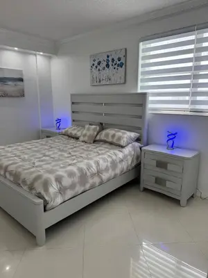 a white bedroom with a large bed and a window at C16P Oceanfront Penthouse in Hollywood FL in Hollywood