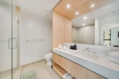 a bathroom with a sink and a toilet and a mirror at Crosby Miami WTC 1BR 1BA Central Stay #1405 in Miami