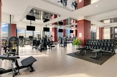 a gym with rows of exercise equipment in a building at Crosby Miami WTC 1BR 1BA Central Stay #1405 in Miami