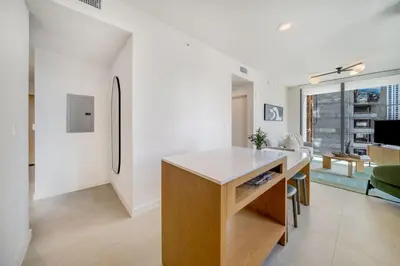 a kitchen with a white counter and a refrigerator at Crosby Miami WTC 2BR 2BA Corner City Residence #601 in Miami