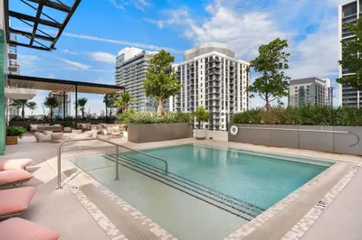 a swimming pool on a building with tall buildings at Crosby Miami WTC 2BR 2BA Corner City Residence #601 in Miami