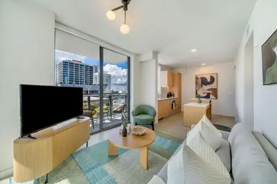 a living room with a large flat screen tv at Crosby Miami WTC 2BR 2BA Corner City Residence #601 in Miami