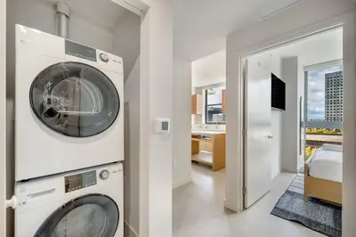 a washer and dryer in a room with a bedroom at Crosby Miami WTC 2BR 2BA Corner City Residence #601 in Miami