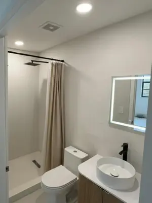 a bathroom with a toilet and a sink and a shower at 1BR near Hollywood Guitar with Private Patio in Hollywood