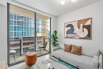 a living room with a couch and a large window at Central Downtown Condo with Pool and Gym in Miami