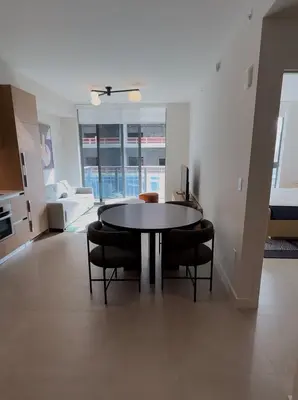 a living room with a table and some chairs at The Crosby Miami World Center in Miami