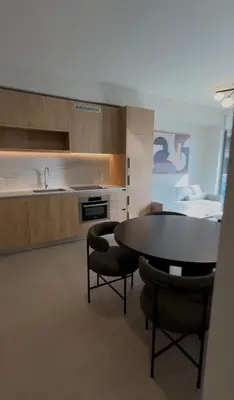 a kitchen with a table and some chairs and a sink at The Crosby Miami World Center in Miami