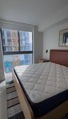a large bed in a room with a large window at The Crosby Miami World Center in Miami