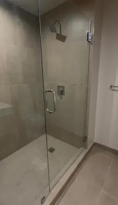 a shower with a glass door in a bathroom at The Crosby Miami World Center in Miami