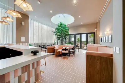 a restaurant with a waiting room with tables and chairs at Sky Sanctuary with Rooftop Pool & Hot tub in Miami