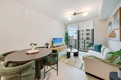 a living room with a table and a couch at Sky Sanctuary with Rooftop Pool & Hot tub in Miami