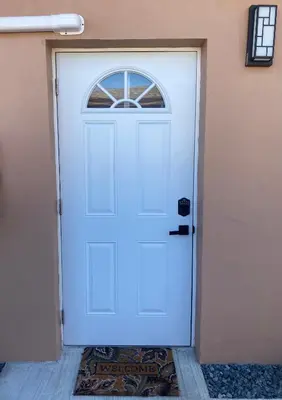 a white door with a window on a building at The Luxe Studio in Miami Gardens