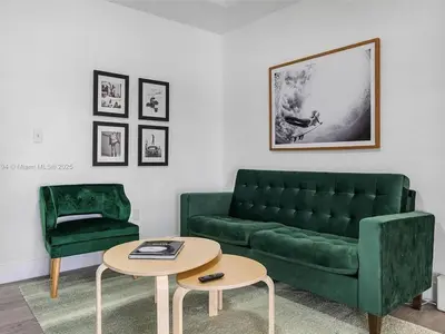 a living room with a green couch and a table at Large 4 bedroom Midtown Great Area in Miami