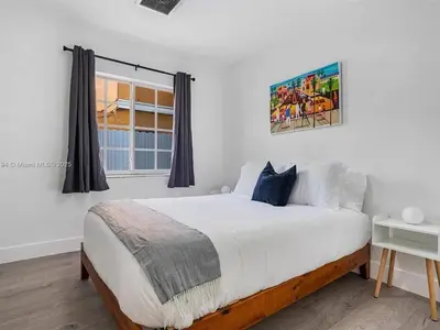 a bedroom with a large bed and a window at Large 4 bedroom Midtown Great Area in Miami