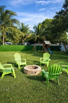 a group of chairs and a fire pit in a yard at Chill Zona Arizona Villa Perfect Cruise Stay in Fort Lauderdale
