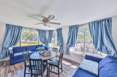 a living room with a blue couch and a table at Chill Zona Arizona Villa Perfect Cruise Stay in Fort Lauderdale