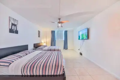 a bedroom with a bed and a ceiling fan at Introdused by Ocean Reserve free parking STR-02559 in Sunny Isles Beach