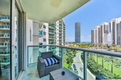 an apartment balcony with a view of the ocean at Introdused by Ocean Reserve free parking STR-02559 in Sunny Isles Beach